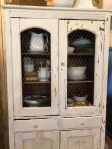 The Junk Parlor gives easy tips to creating vignettes inside a closed cabinet.