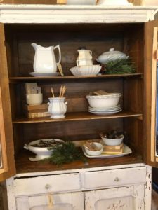 The Junk Parlor gives easy tips to creating vignettes inside a closed cabinet.