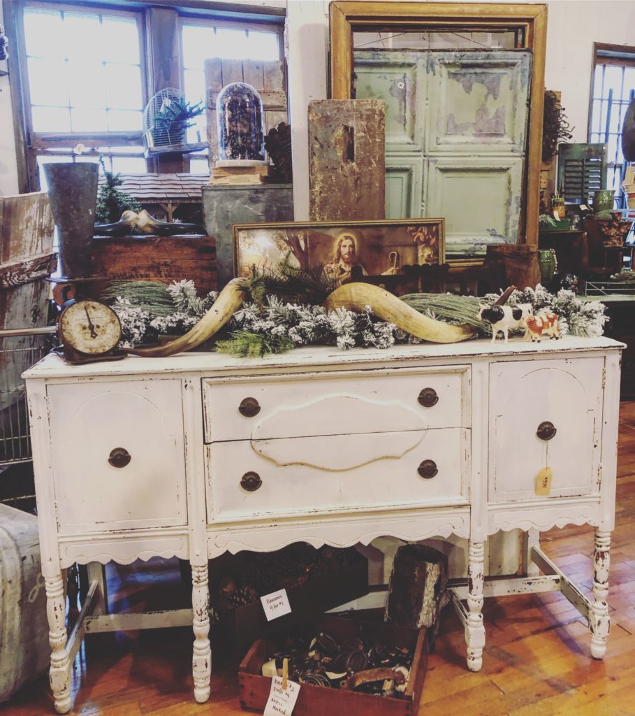 close up of white buffet painted with milk paint with accessories