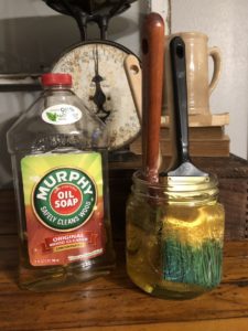 Dried up paintbrushes soaking in Murphy's Oil Soap