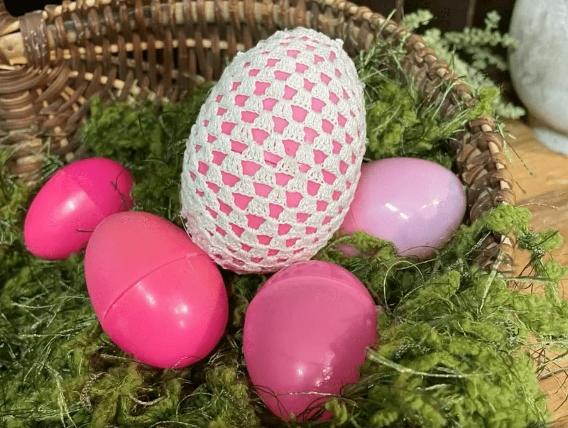 Plastic Easter eggs, one covered with doilies 