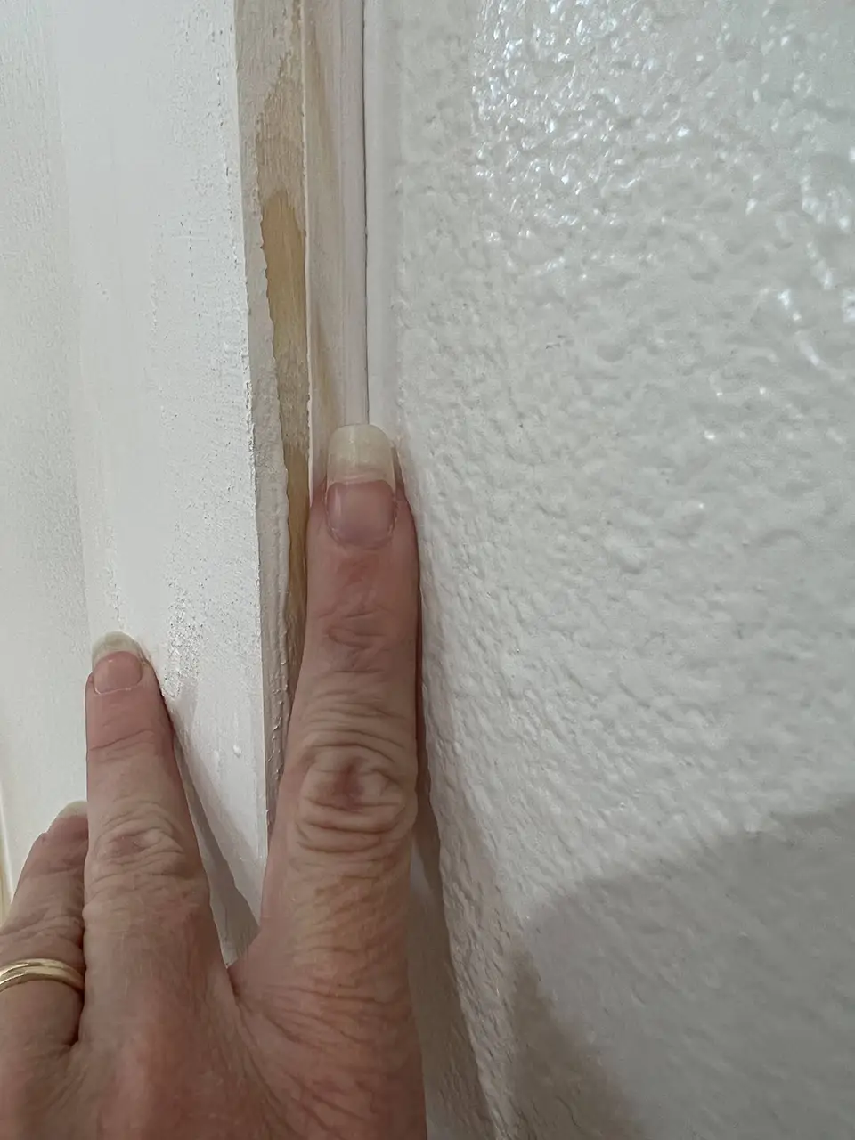 My finger smoothing out the caulking.  Brooke Johnson | The Junk Parlor | Old stuff and cool junk for your home | Business Coach for Antique Dealers | thejunkparlor.com