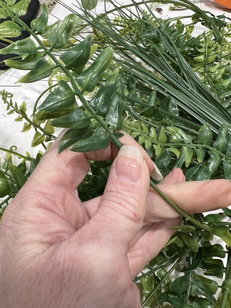 Removing a tip from a stem of greenery