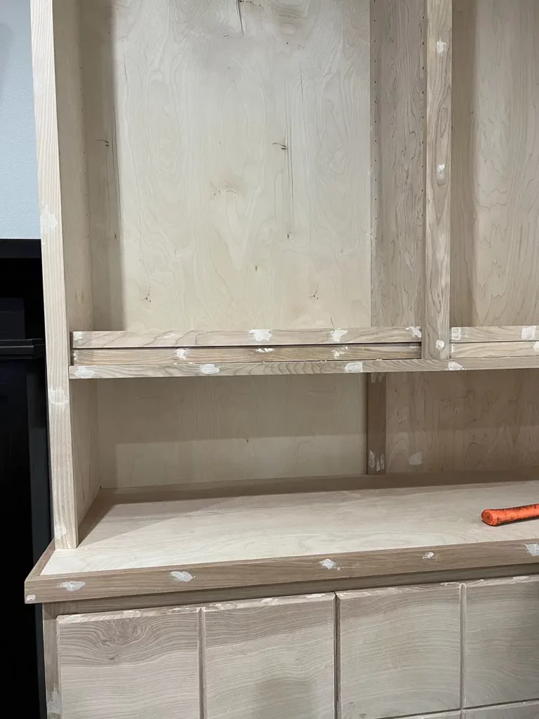 Built-ins with wood filler in the nail holes before sanding