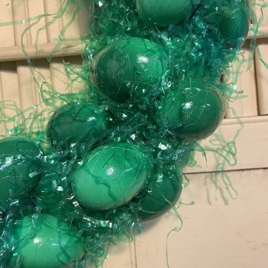 Upclose of Easter egg wreath with the faux grass filler