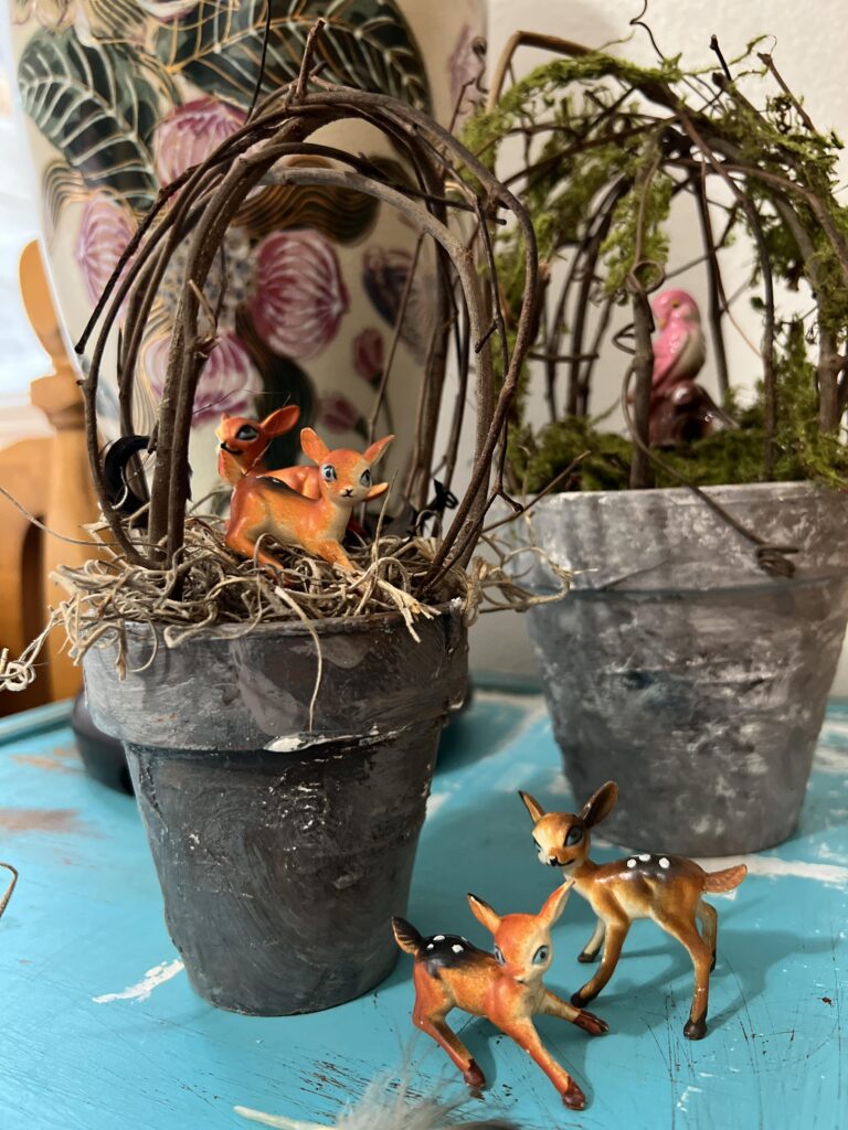 vintage miniature deer inside and in front of a topiary