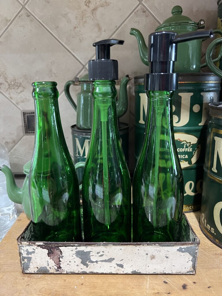 Green bottles, 2 have different styles of spouts on them