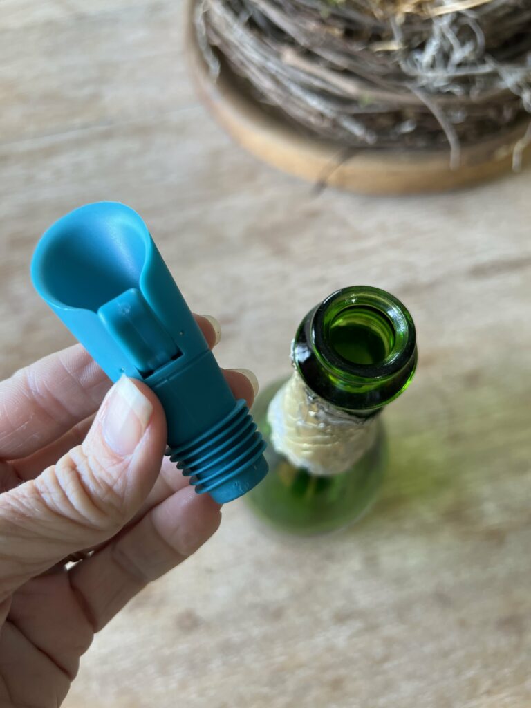 Colorful spout and a green bottle