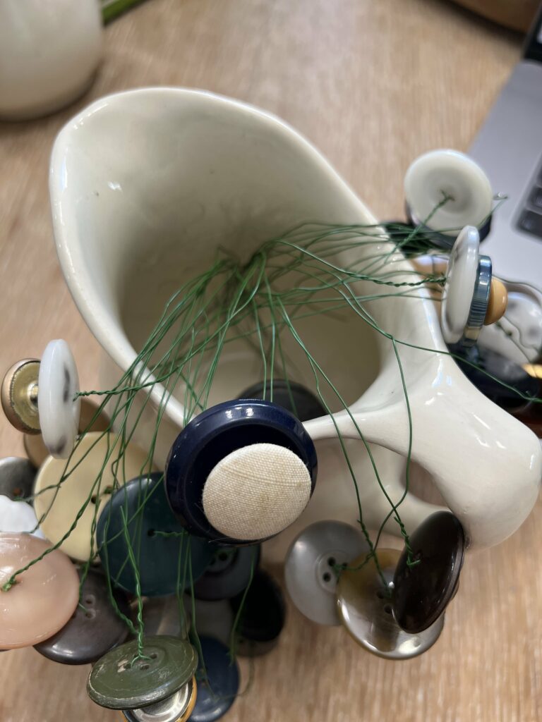 DIY flower buttons with only the floral wire in a white pitcher