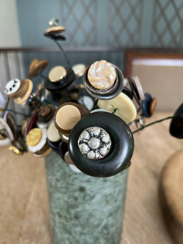 Vintage button flowers in a green alabaster vase
