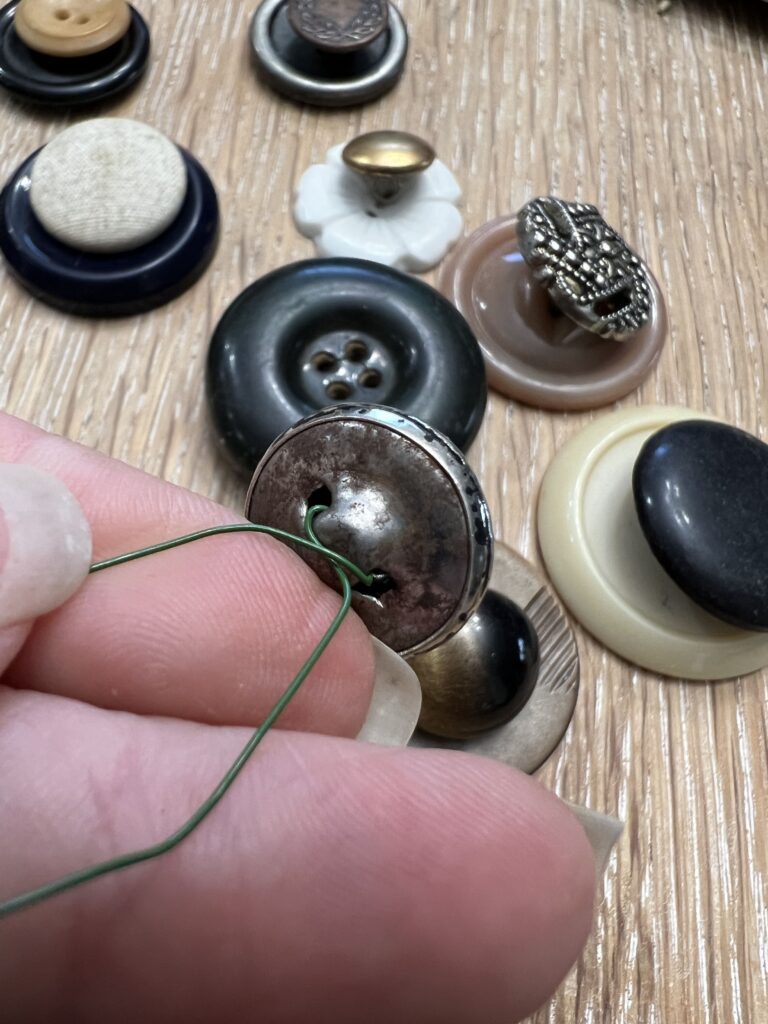 back of a button getting wire ran through the holes