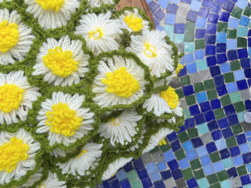 daisy blanket on blue tiled table at Turquoise Vintage