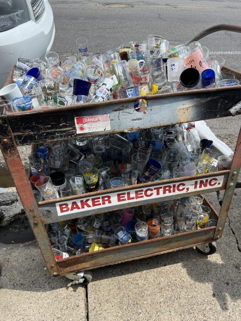 tons of small bottles on an old metal cart