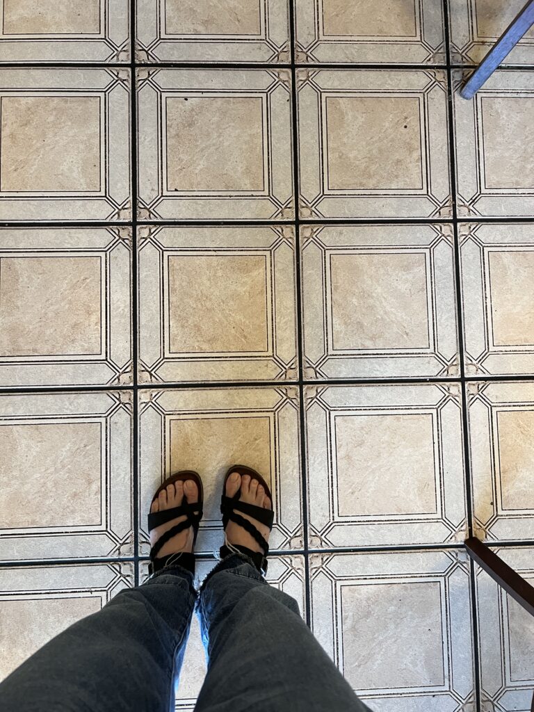 My feet and the floor  at Travel By Taste