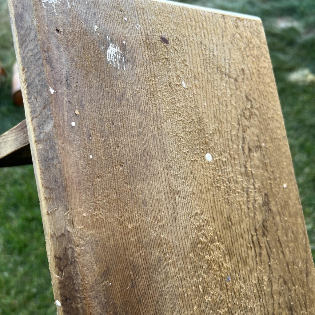 top of bench that shows the wood texture/peeling