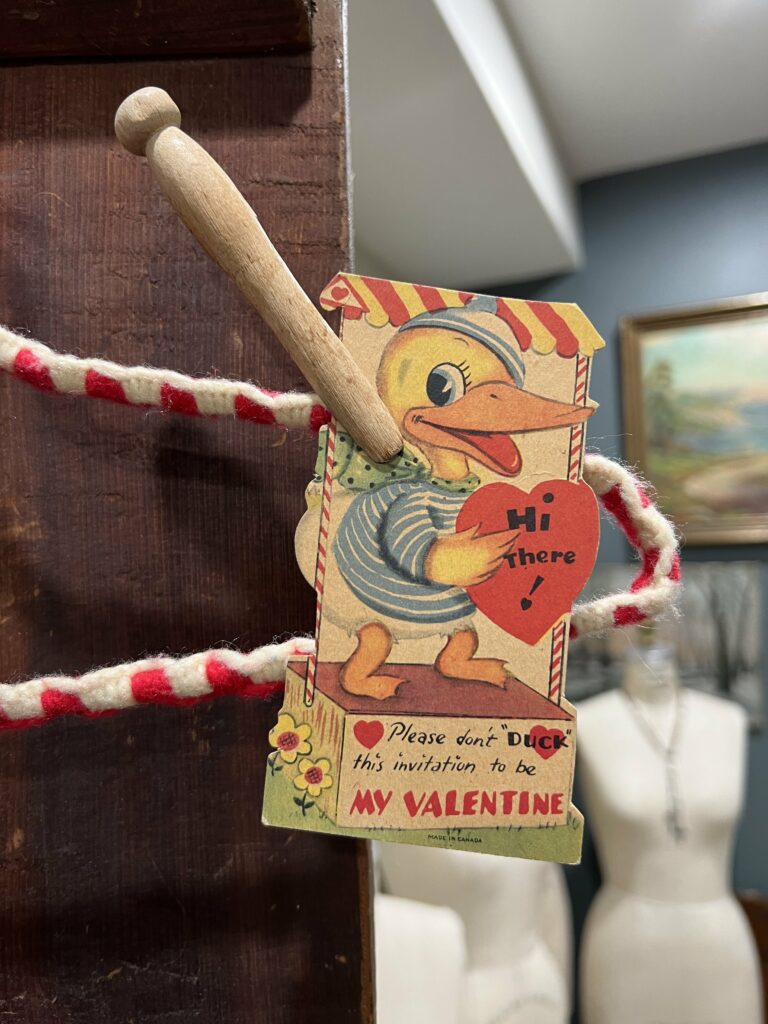 upclose of Valentine's clipped to an old hanger.