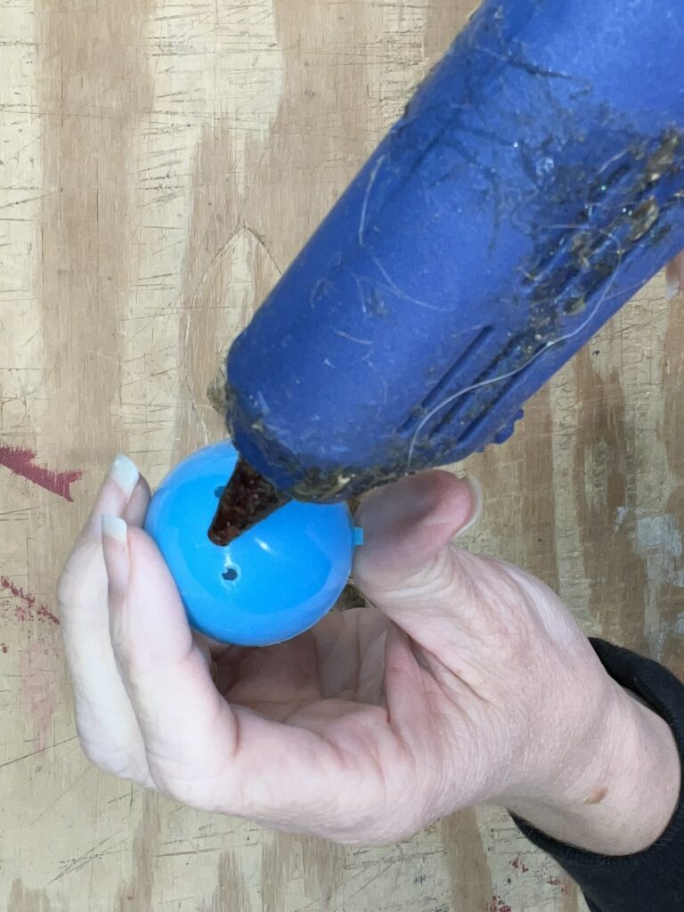 Glue gun and one end of an egg