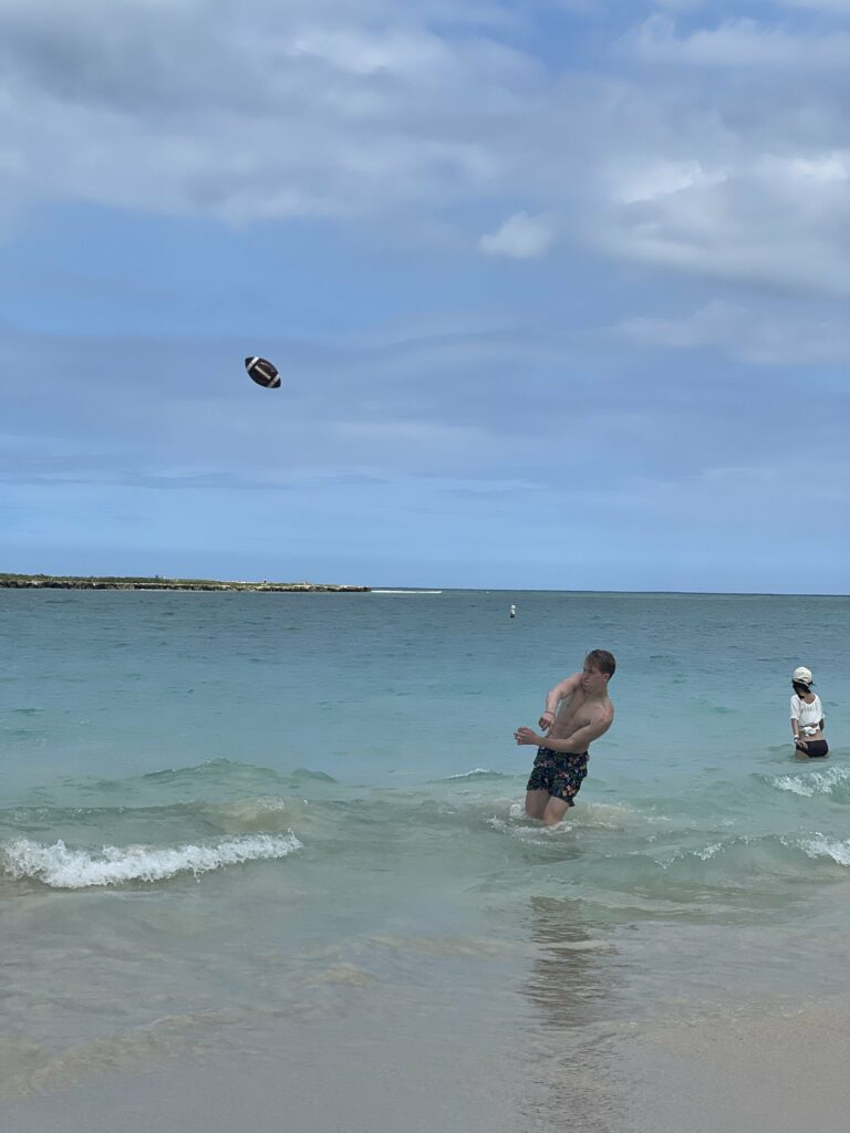 Kash throwing the football at Kailua beach