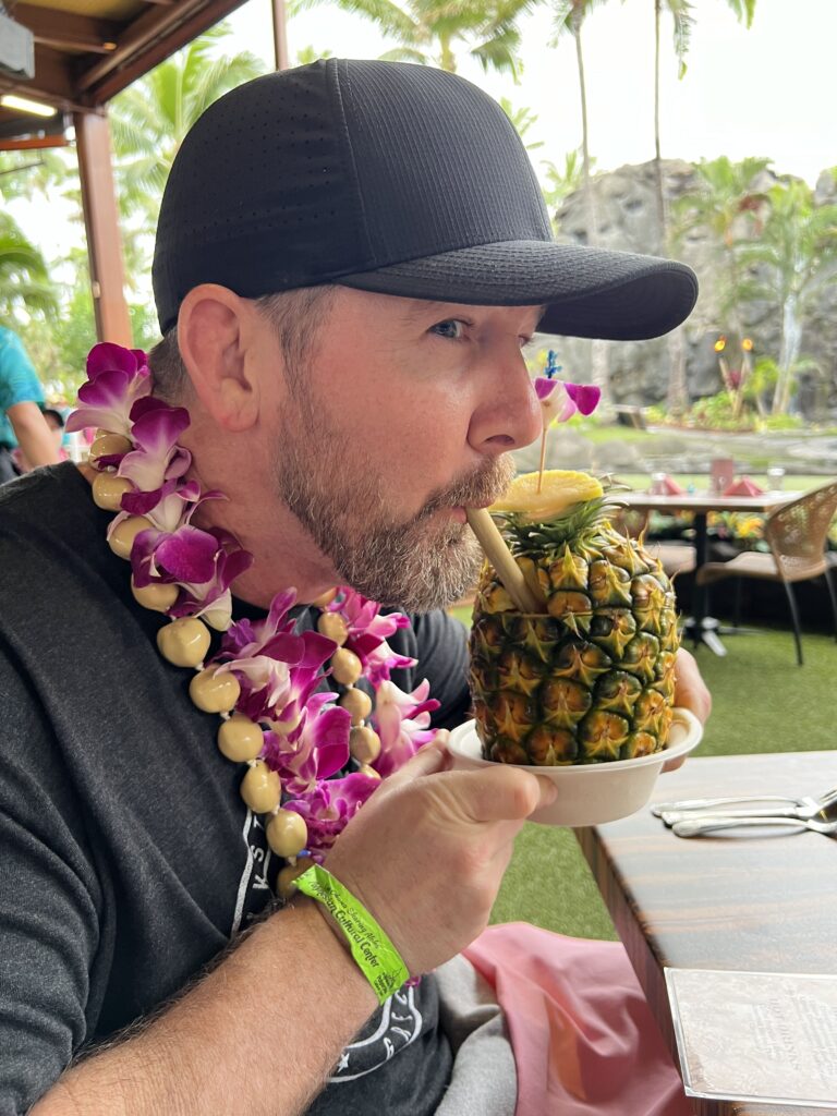 Hubby with his pineapple drink at the Luau