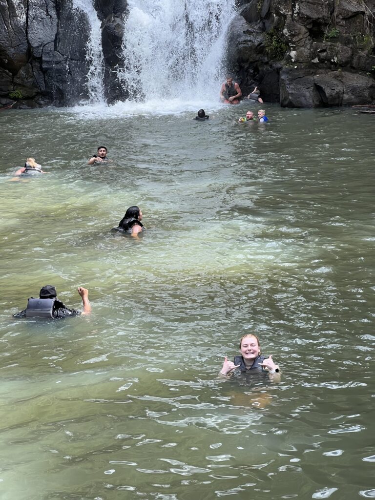 Kyler in cold water at the base of Waimea Falls 