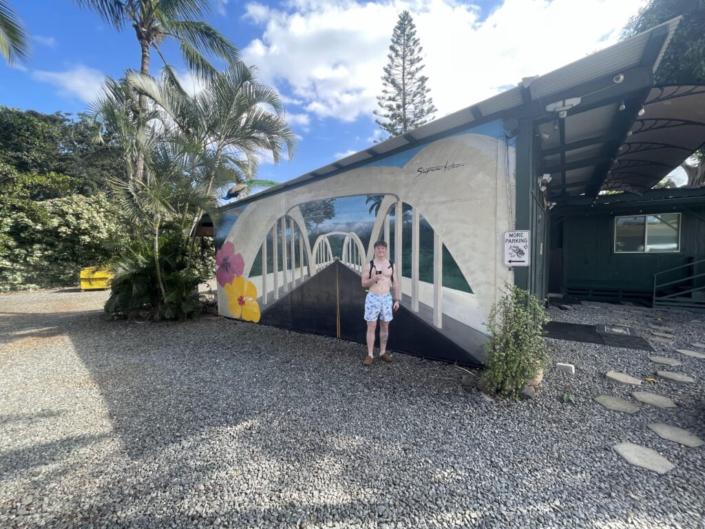 Kellen in front of a mural in Haleiwa