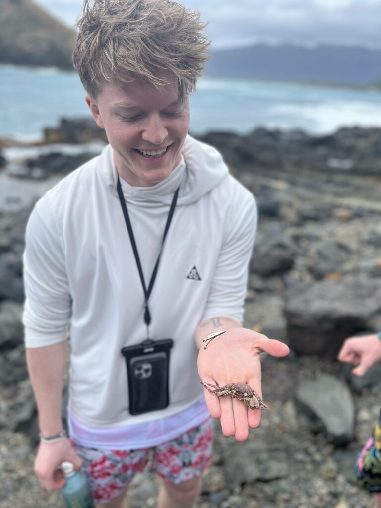 Kellen holding a dead crab of some kind