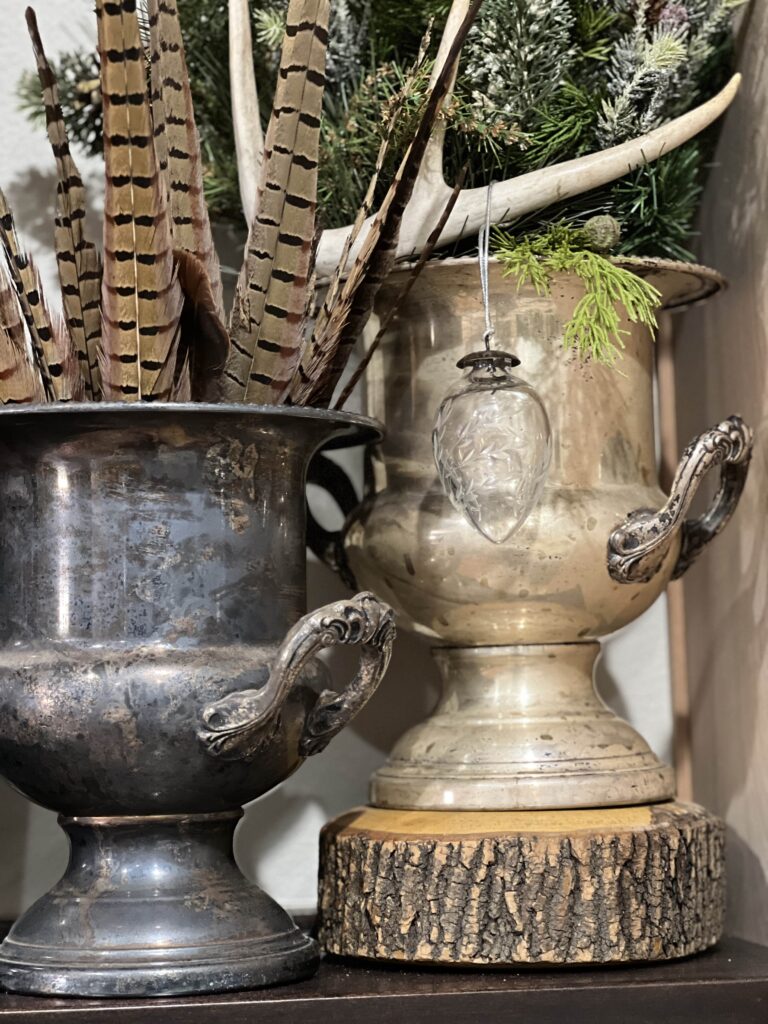 Layers - Wood nut bowl, silver plate trophy cup, feathers|antlers|greenery.
